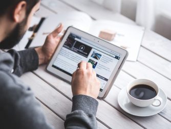 Image of man using touchscreen to prepare for book launch