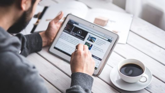 Image of man using touchscreen to prepare for book launch